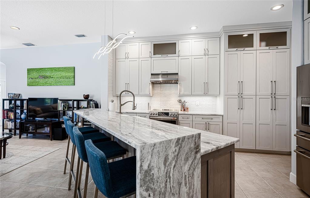 956 Scherer Way Osprey, FL 34229 - Photo 6 of 38 a kitchen with stainless steel appliances granite countertop a sink stove and cabinets