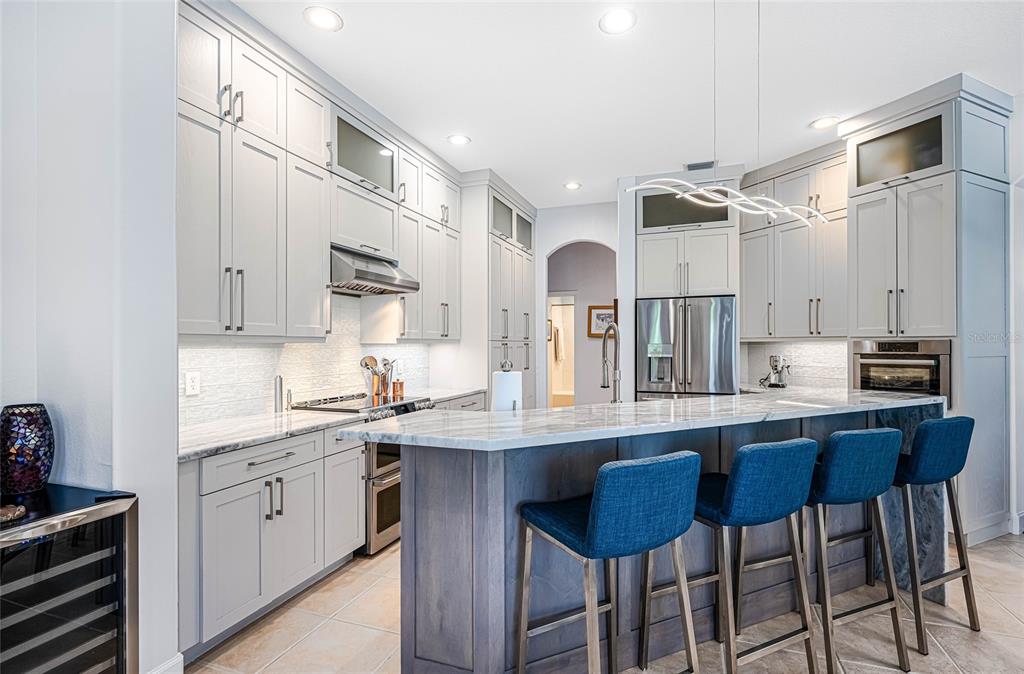 956 Scherer Way Osprey, FL 34229 - Photo 7 of 38 a kitchen with cabinets and chairs in it