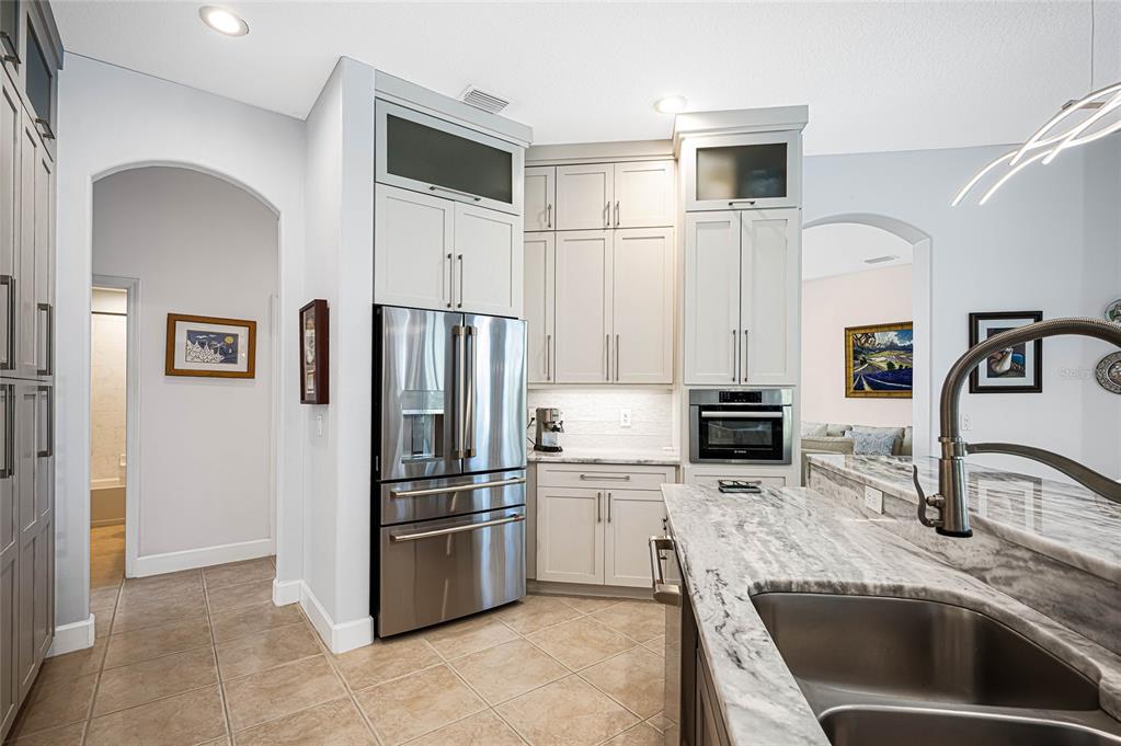 956 Scherer Way Osprey, FL 34229 - Photo 8 of 38 a kitchen with granite countertop a refrigerator and a sink