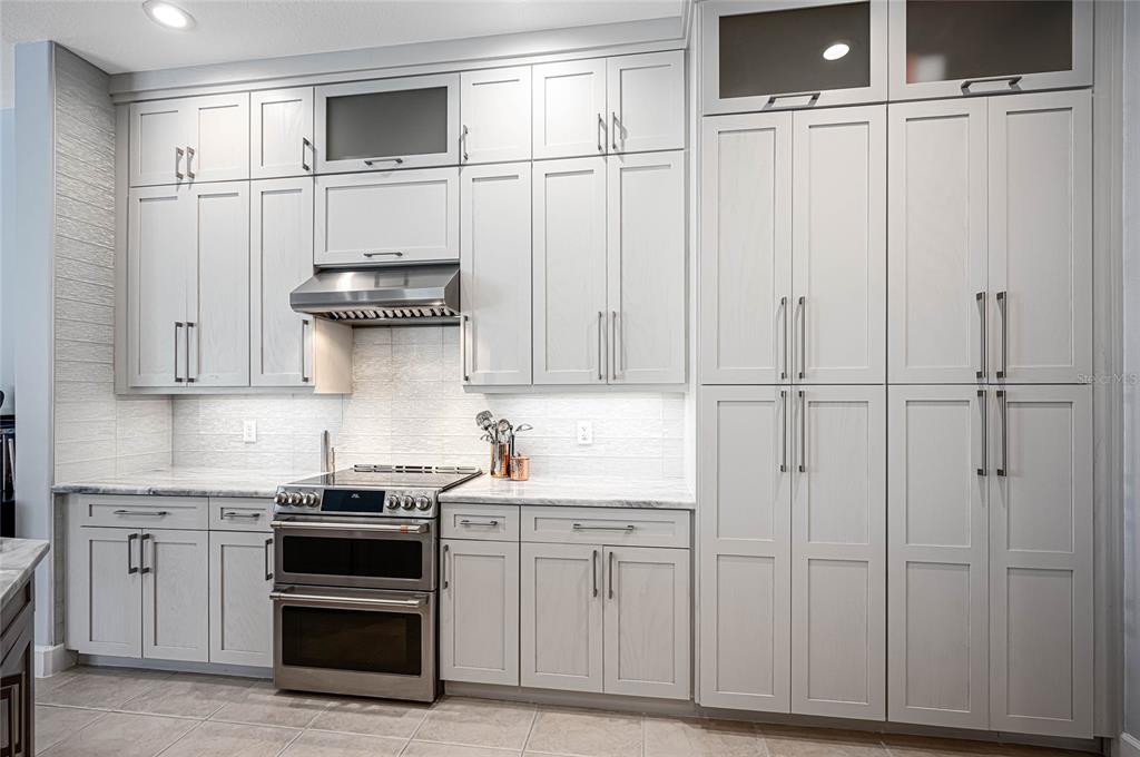 956 Scherer Way Osprey, FL 34229 - Photo 9 of 38 a kitchen with white cabinets and white appliances