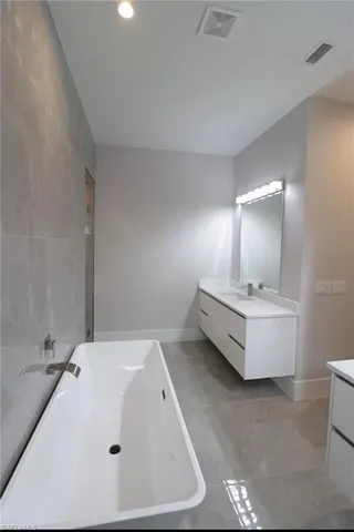 a bathroom with a sink and mirror