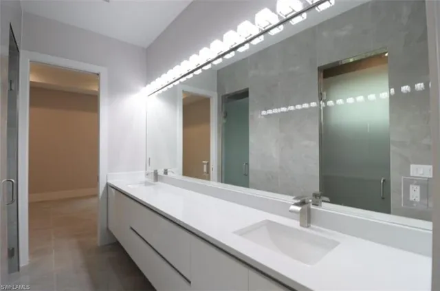a bathroom with a glass shower door