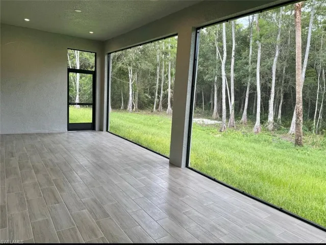 a kitchen with a stove and a wooden floor