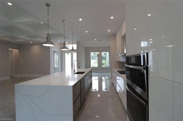 a large kitchen with a large counter top appliances and cabinets
