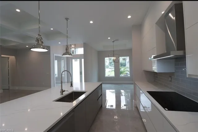 a kitchen with stainless steel appliances granite countertop a sink a stove and a refrigerator