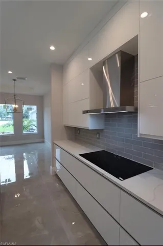 a kitchen with a sink a microwave and cabinets