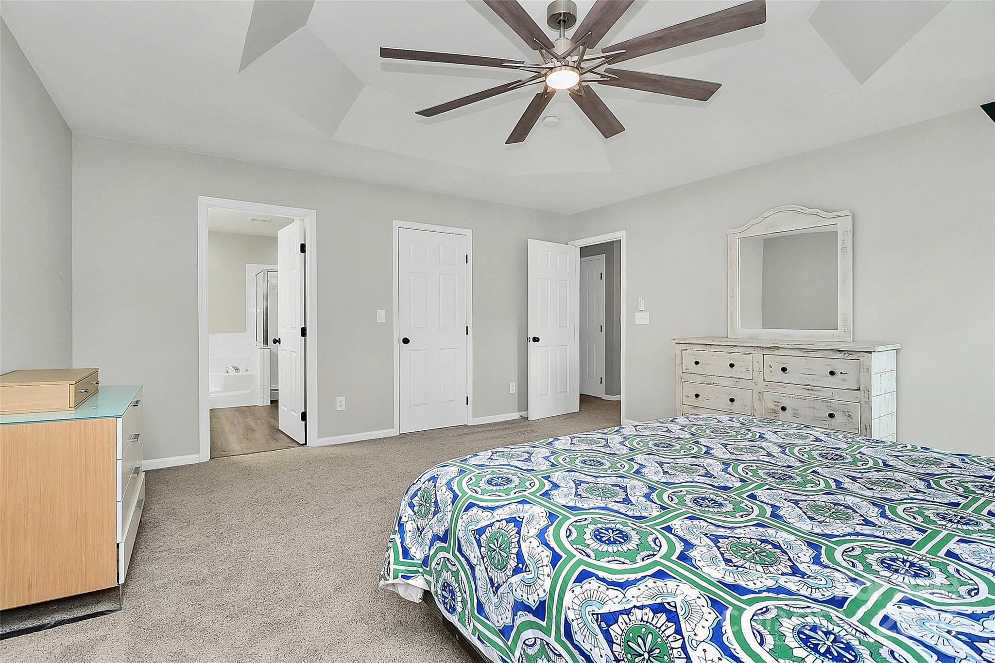 536 St George Road Fort Mill, SC 29708 - Photo 33 of 48 a bedroom with a bed and a chandelier