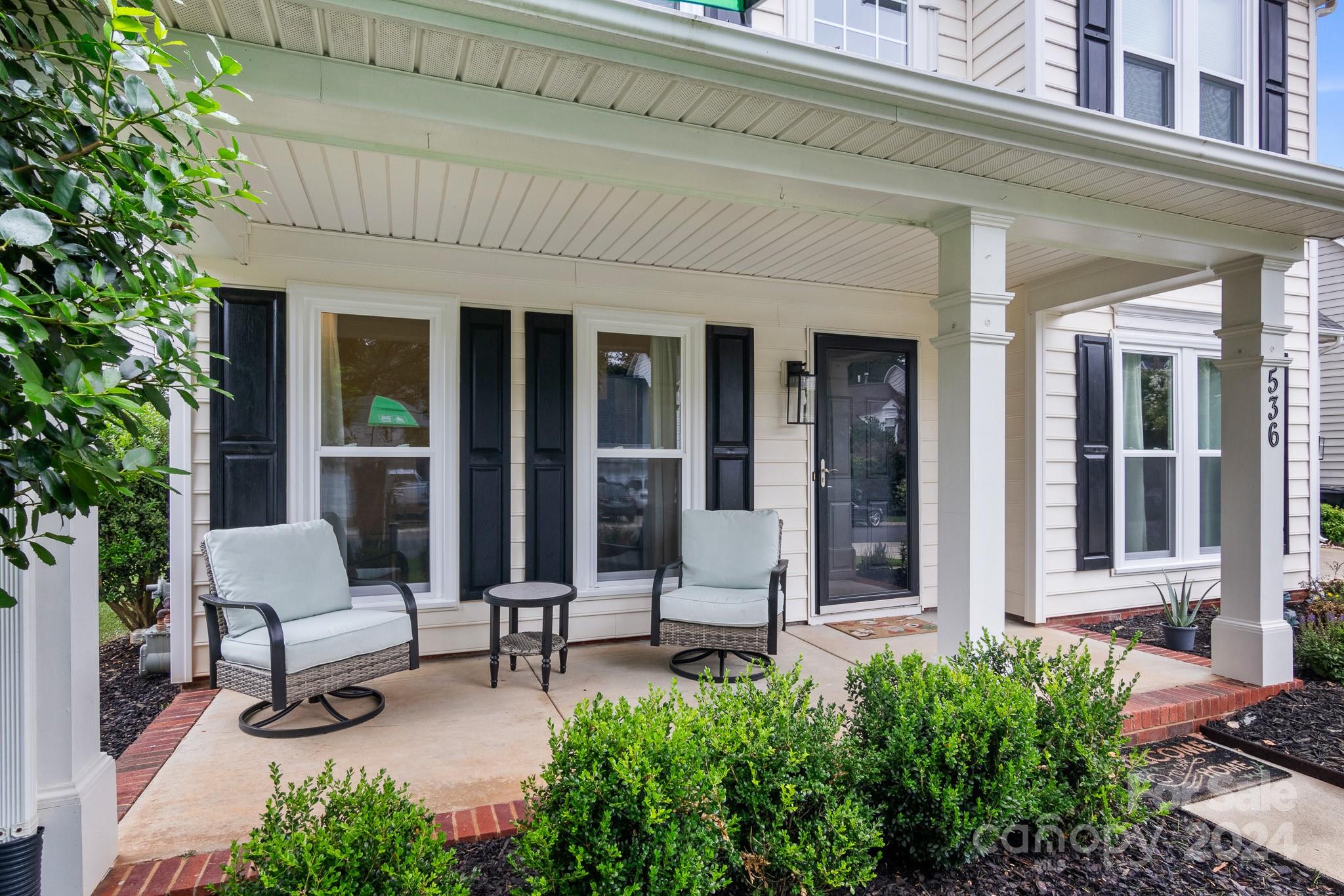 536 St George Road Fort Mill, SC 29708 - Photo 4 of 48 front view of brick house with a chairs and table in a patio