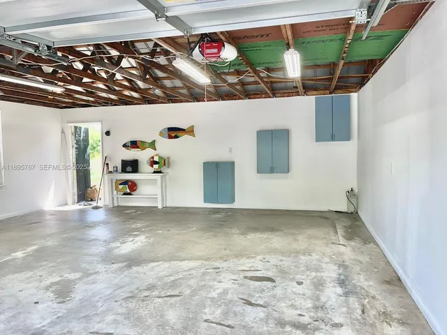 a kitchen with stainless steel appliances a refrigerator sink and wooden floor
