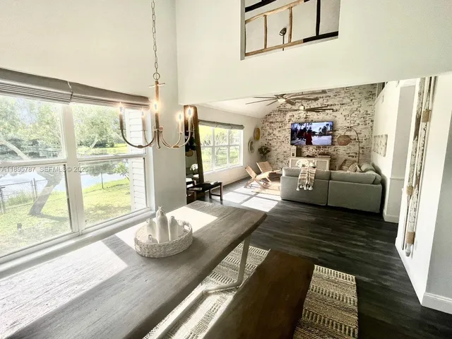 a large white kitchen with cabinets a sink and stainless steel appliances