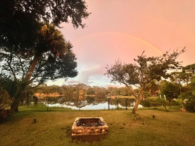 a view of a house with swimming pool and sitting area