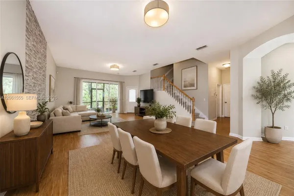 a view of a dining room with furniture and wooden floor