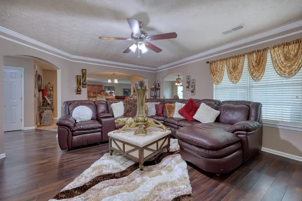 a living room with furniture and wooden floor