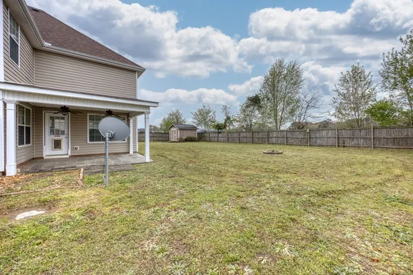 a view of a house with backyard