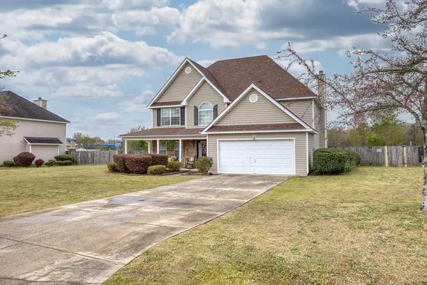 a front view of a house with a yard and garage