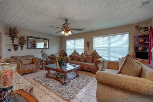 a living room with furniture and a large window