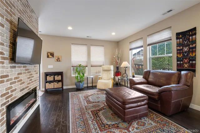 a living room with fireplace furniture and a flat screen tv