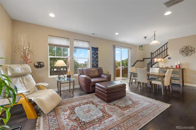 a living room with furniture a rug and a large window