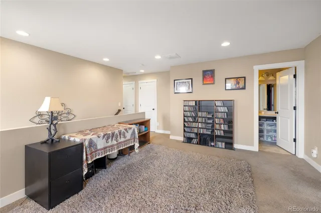a spacious bedroom with a bed and a desk