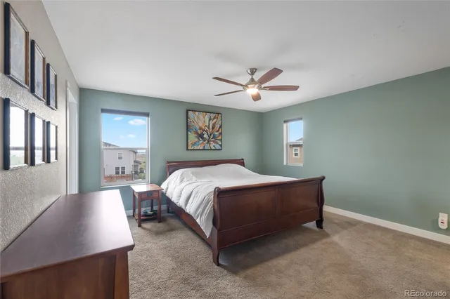 a spacious bedroom with a bed and a chandelier