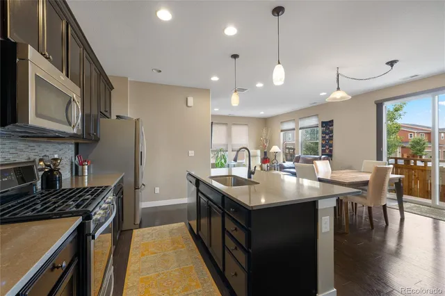 a kitchen with lots of counter space a sink appliances and cabinets