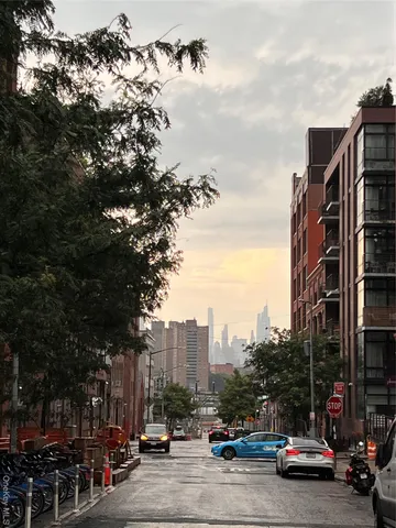 a city street with cars parked in front of it