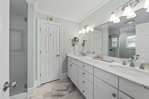 a bathroom with double sink and a mirror