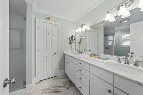 a bathroom with double sink and a mirror