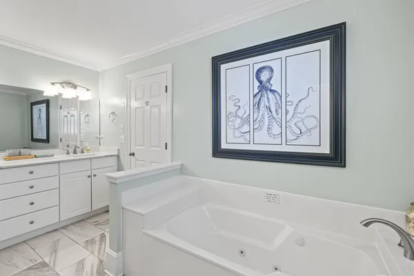 a white bath tub sitting next to a bathroom sink