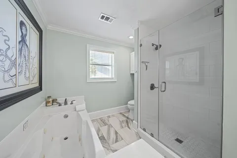 a bathroom with a bathtub and a shower