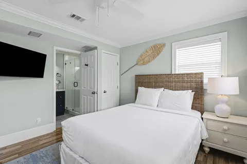 a bedroom with a bed and a flat tv screen