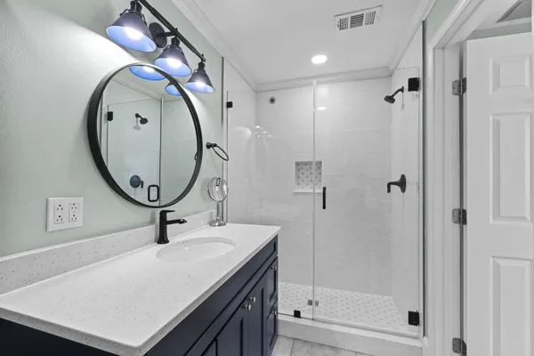 a bathroom with a mirror and a sink