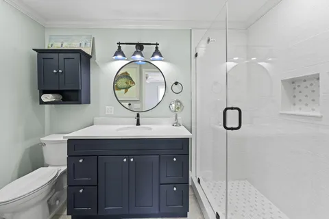 a bathroom with a sink a toilet and a mirror