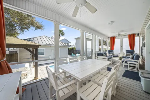 a view of a dining room with furniture a chandelier and wooden floor