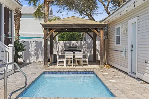 a view of a chairs with barbeque grill and wooden floor