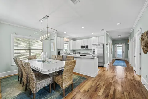 a large kitchen with a table and chairs