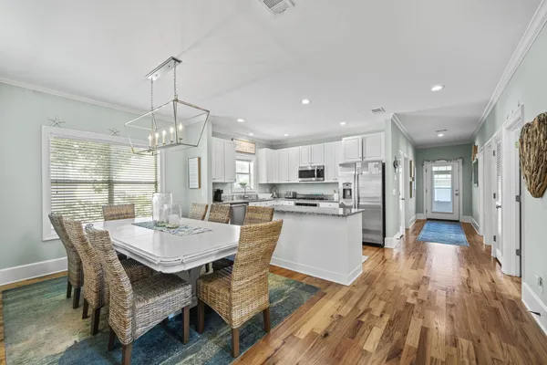 a large kitchen with a table and chairs