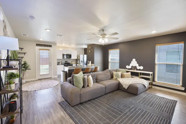 a living room with furniture and a wooden floor