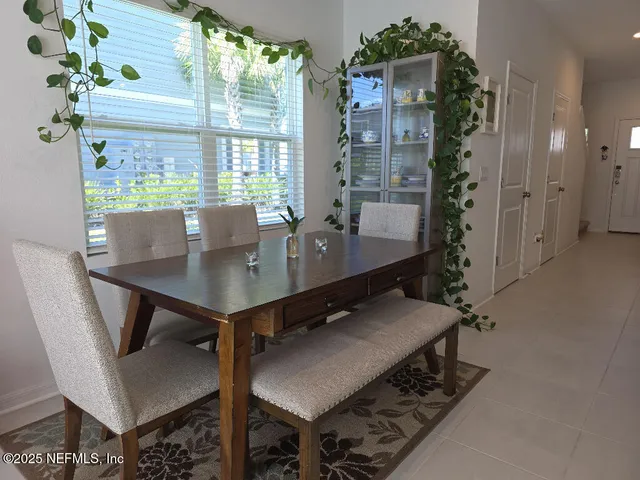 a view of a dining room with furniture and window