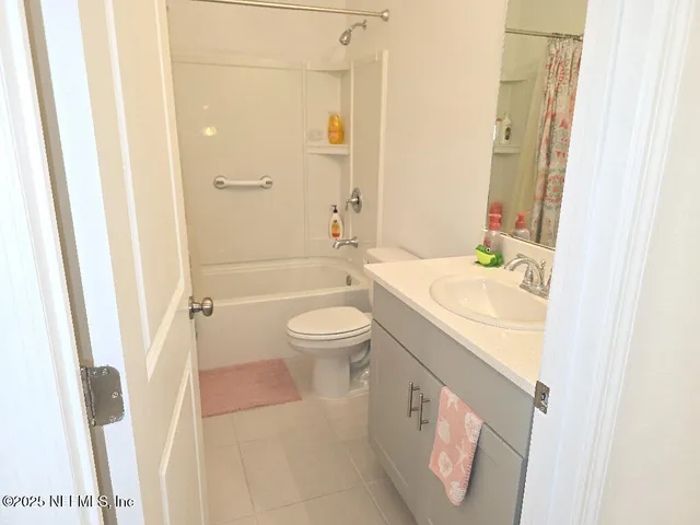 a bathroom with a sink a toilet a tub and shower