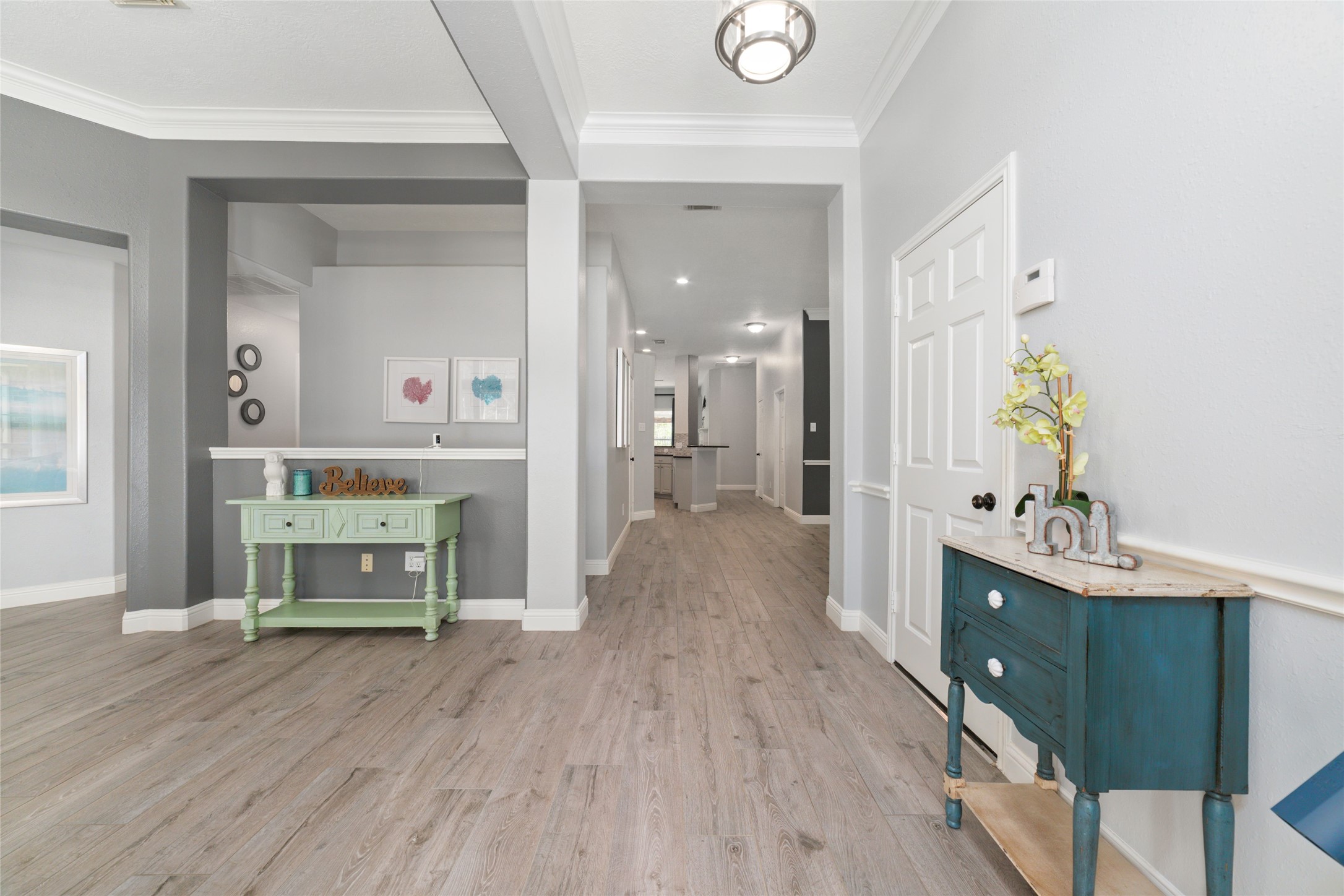 24203 Moon Ridge Court Katy, TX 77494 - Photo 5 of 43 Welcoming entryway with light wood look tile floors and fresh paint through out! Modern updated decorated home leads into a spacious, open hallway with recessed lighting. This home is turn key ready!