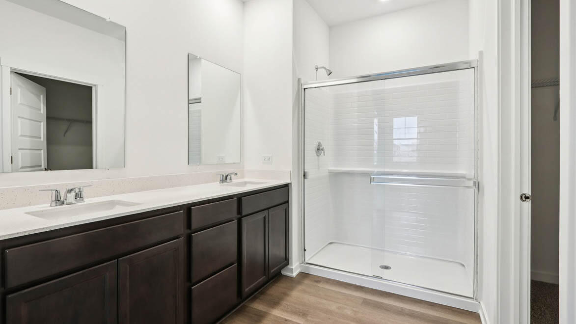 7641 West 106th Place Crown Point, IN 46307 - Photo 25 of 31 a bathroom with a double vanity sink mirror and shower