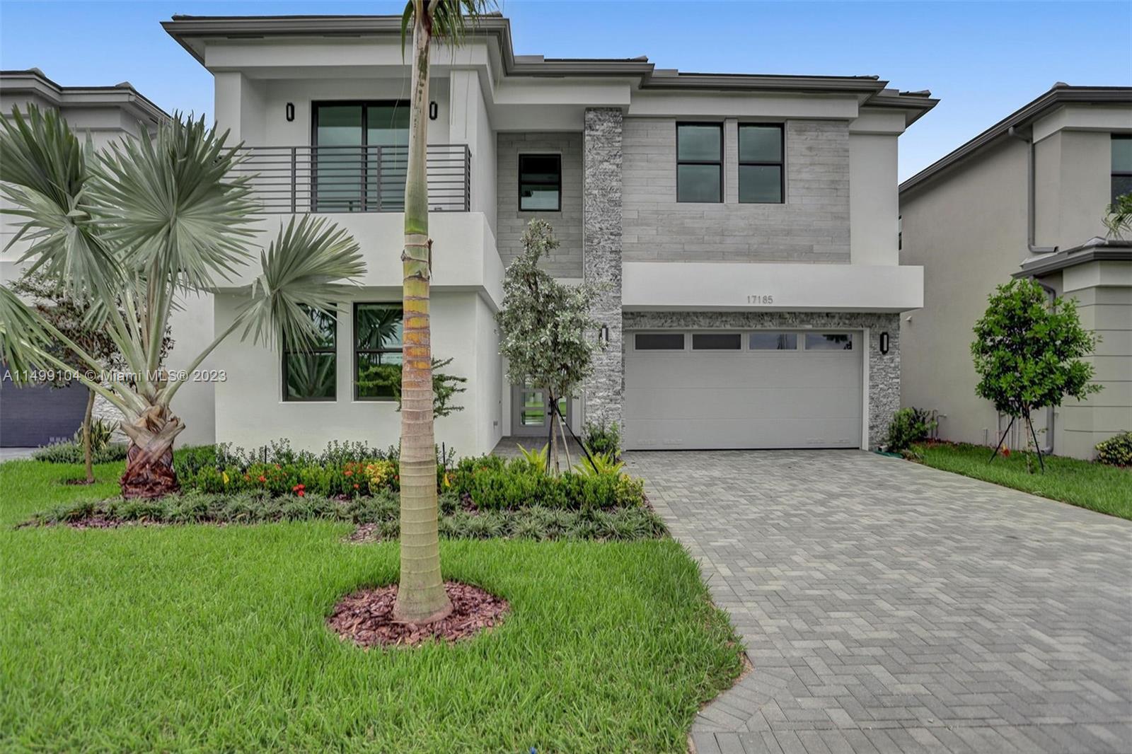 17185 Teton River Road Boca Raton, FL 33496 - Photo 2 of 89 a front view of a house with a garden and plants