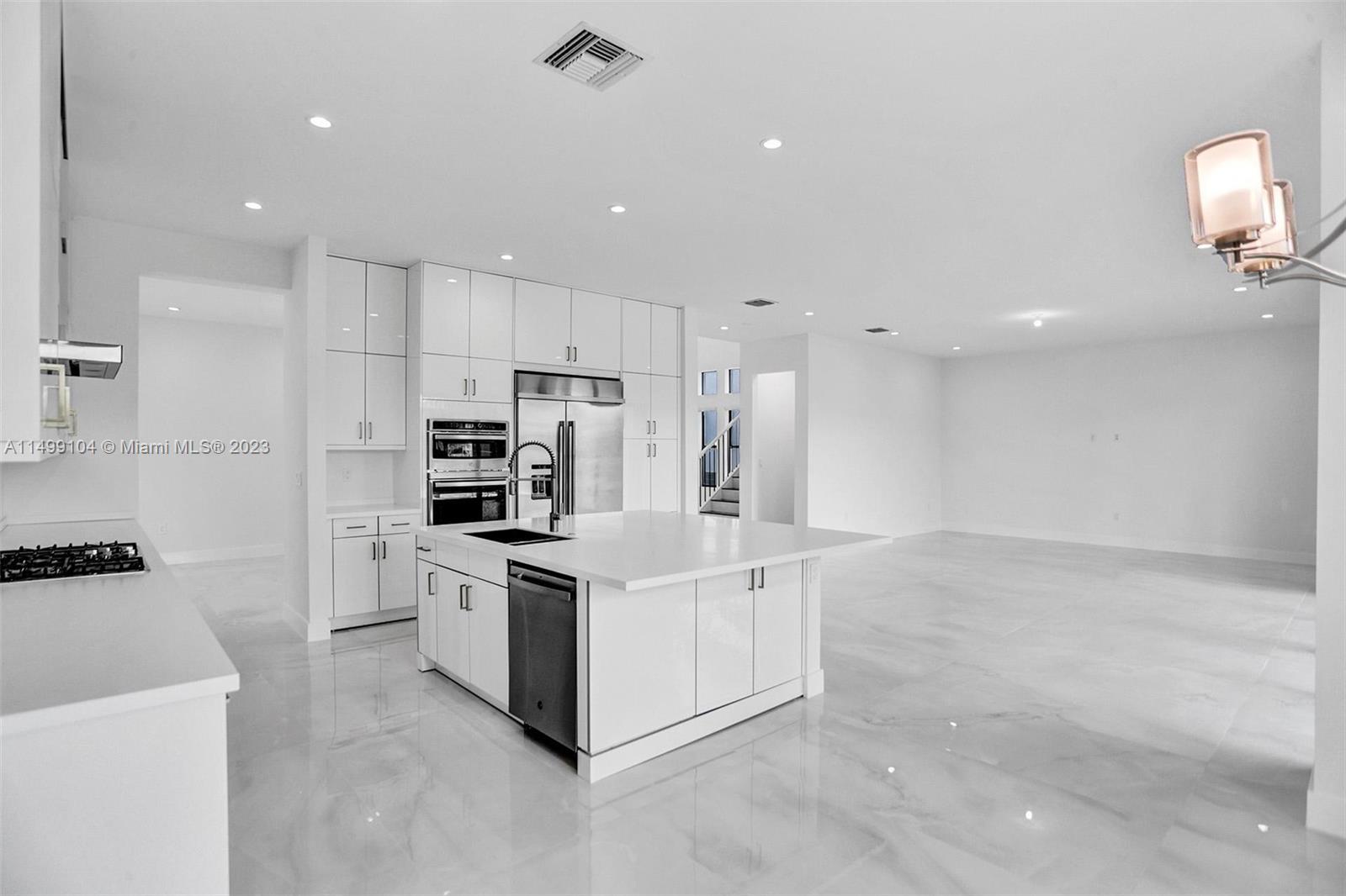 17185 Teton River Road Boca Raton, FL 33496 - Photo 22 of 89 a kitchen with stainless steel appliances white cabinets and a refrigerator