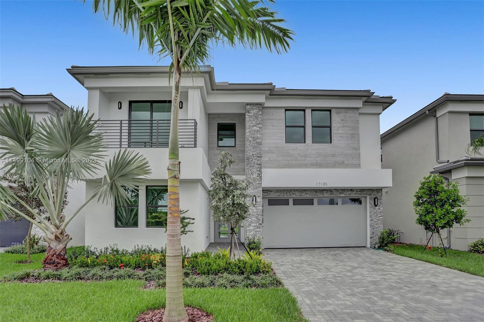 17185 Teton River Road Boca Raton, FL 33496 - Photo 3 of 89 a front view of a house with a garden