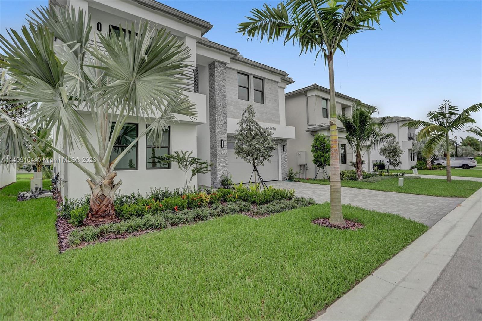 17185 Teton River Road Boca Raton, FL 33496 - Photo 4 of 89 a front view of a house with garden