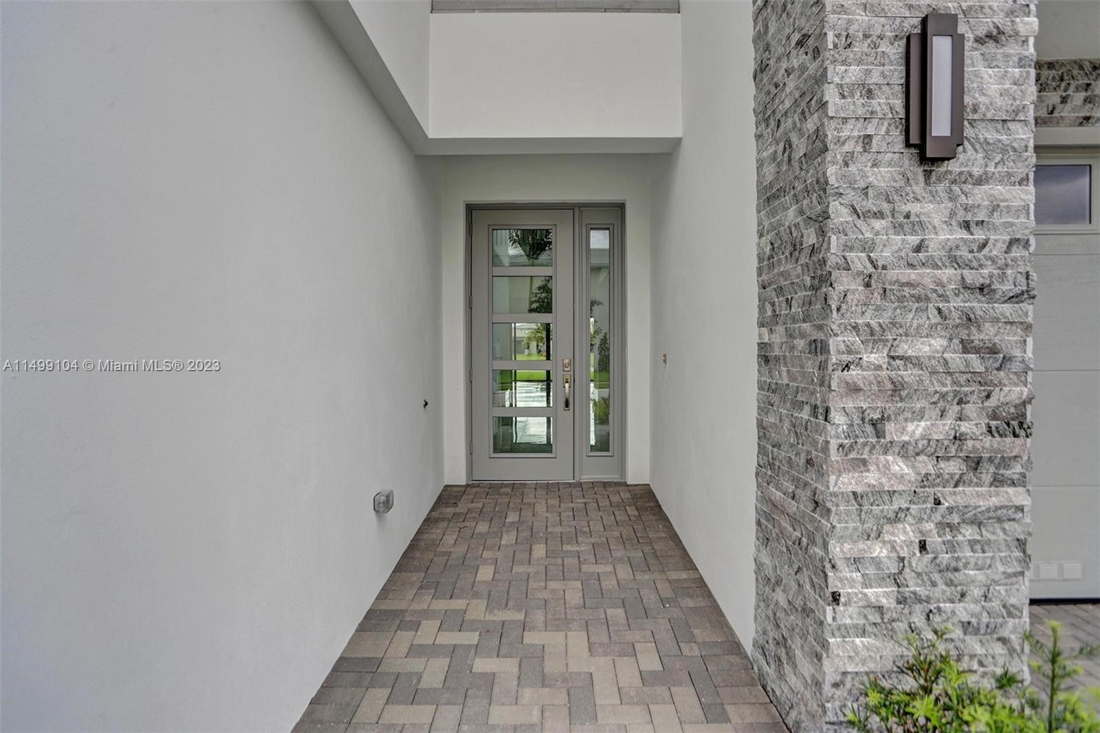 17185 Teton River Road Boca Raton, FL 33496 - Photo 5 of 89 a view of a hallway with wooden floor and a bathroom