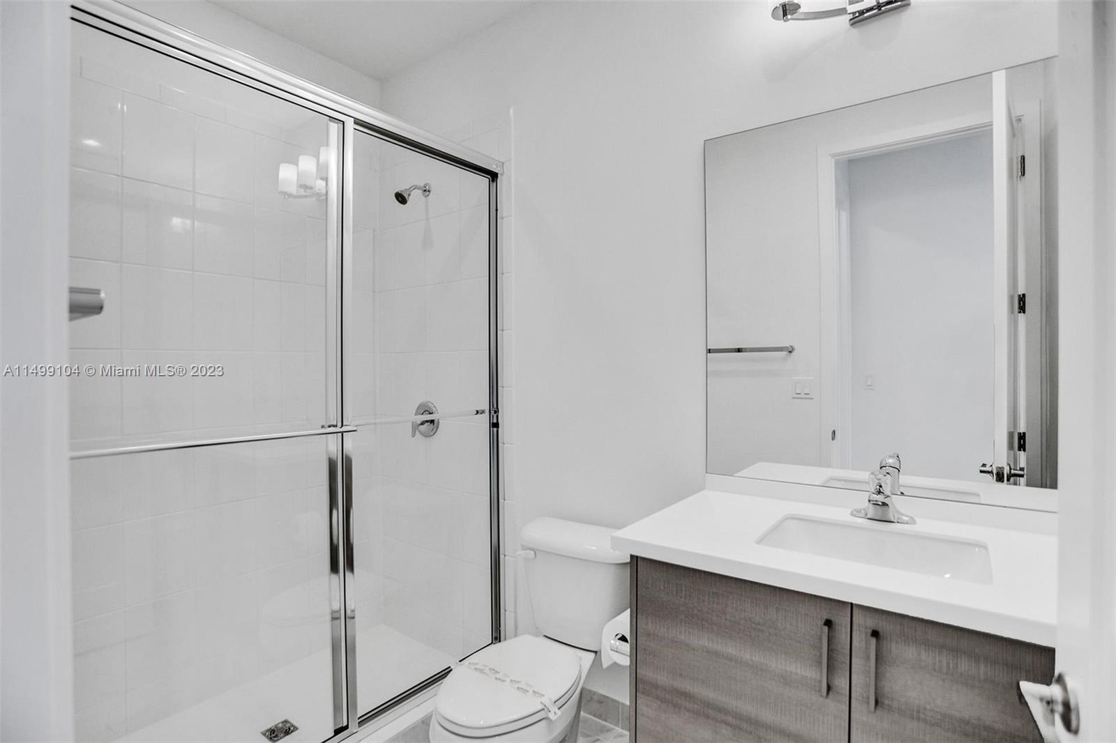 17185 Teton River Road Boca Raton, FL 33496 - Photo 52 of 89 a bathroom with a sink toilet a mirror and shower