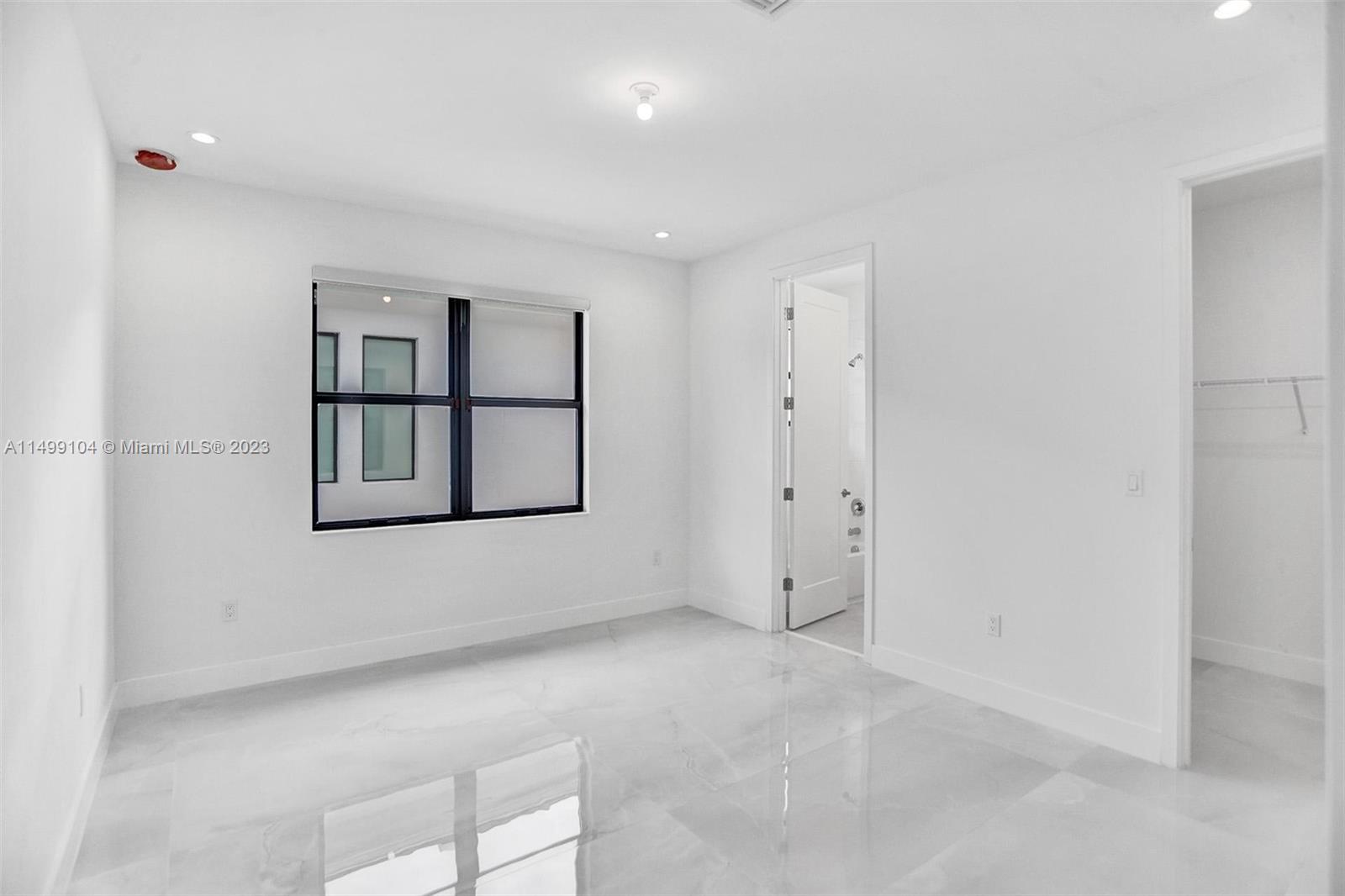 17185 Teton River Road Boca Raton, FL 33496 - Photo 53 of 89 an empty room with windows and cabinet