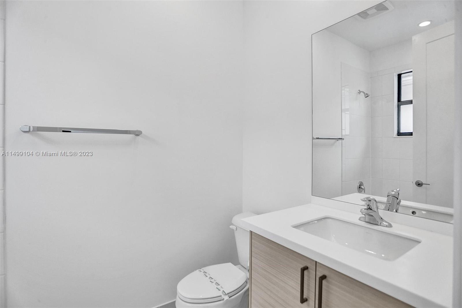 17185 Teton River Road Boca Raton, FL 33496 - Photo 55 of 89 a bathroom with a sink a toilet and mirror